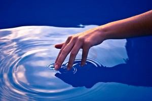 A hand touching water