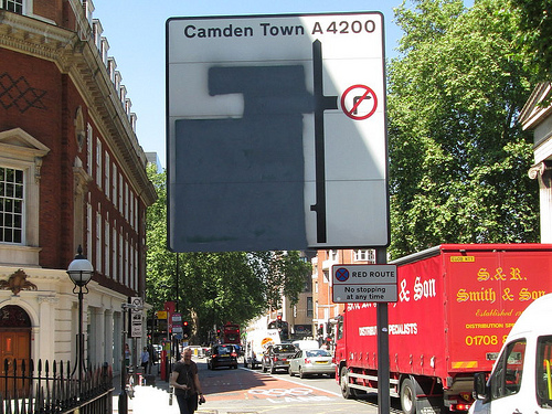 A road sign rendered meaningless by blacked out parts because of the Olympics