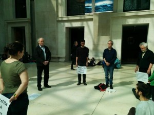 Quakers worshipping at the British Museum while holding placards.
