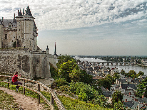 A view from a hill of Saumur in France, with the castle on the left and the river in the distance.