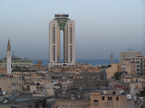 A tall tower with older buildings in the foreground in Tripoli, Libya.