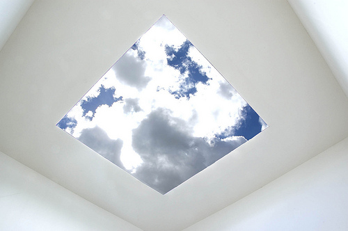 Clouds edged with silver light seen through a skyspace