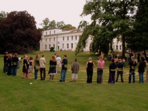 People standing in a labyrinth cut into grass in the Woodbrooke garden