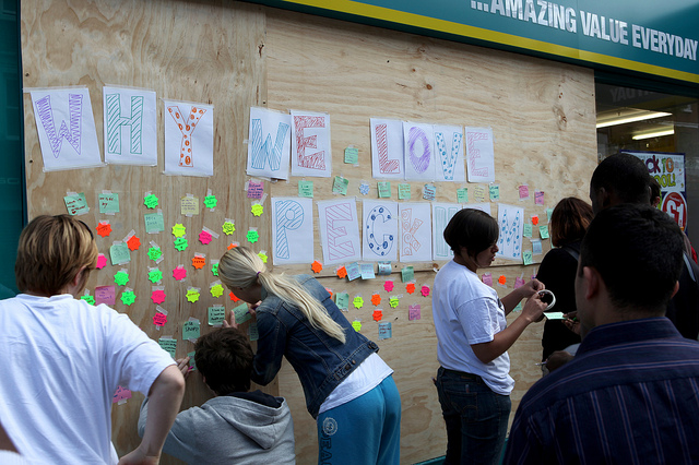 People adding messages to a board about why they love Peckham
