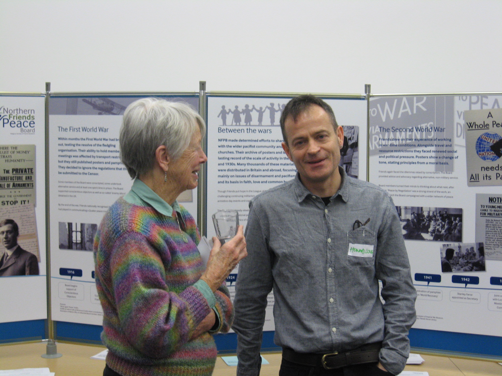 Two people chatting in front of display boards to celebrate 100 years of NFPB.